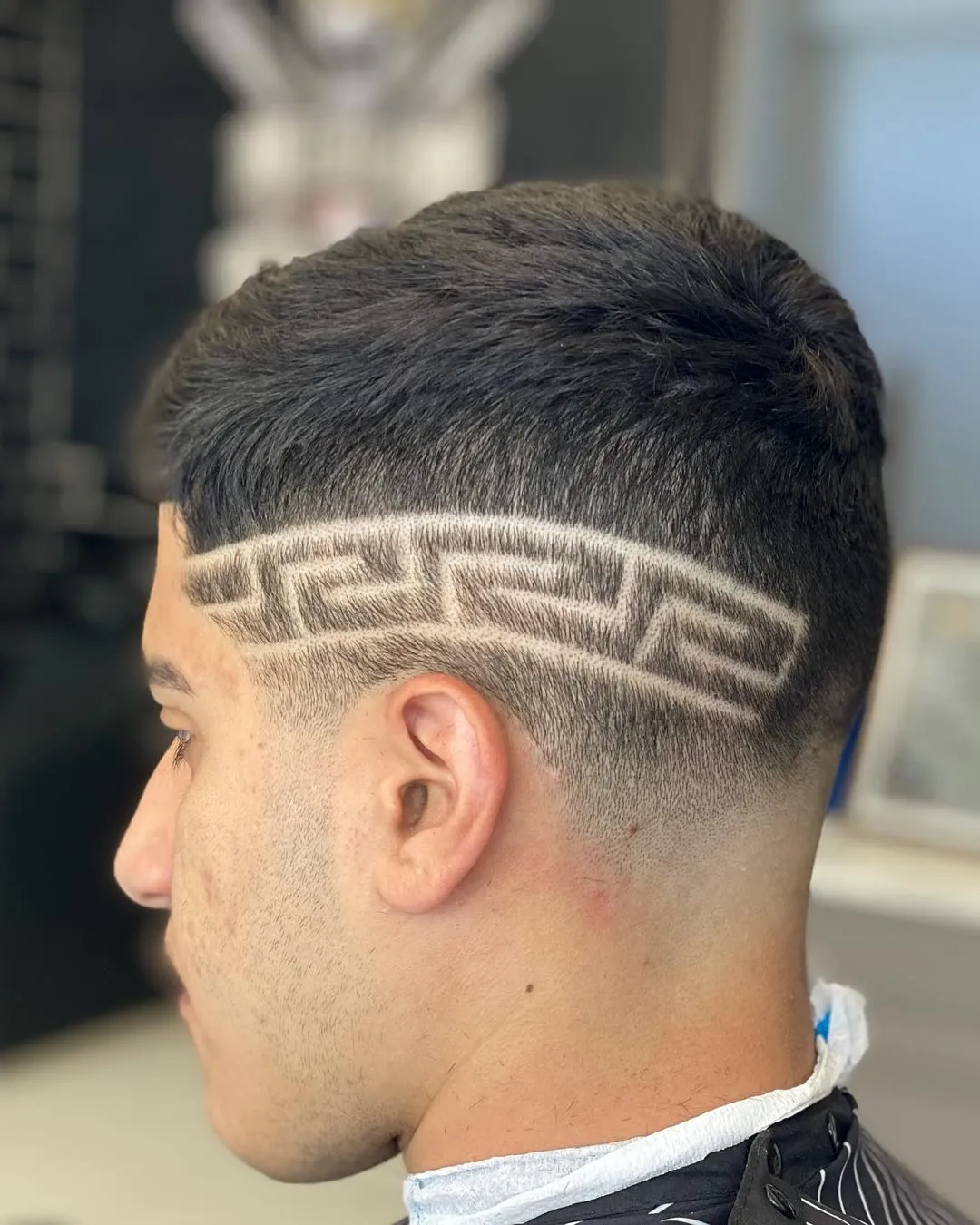 Greek key pattern cut into a low skin fade