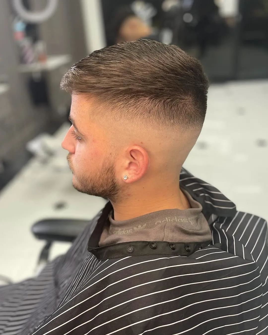 Short textured top with a sharp mid fade